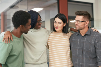 four people coming together to embrace